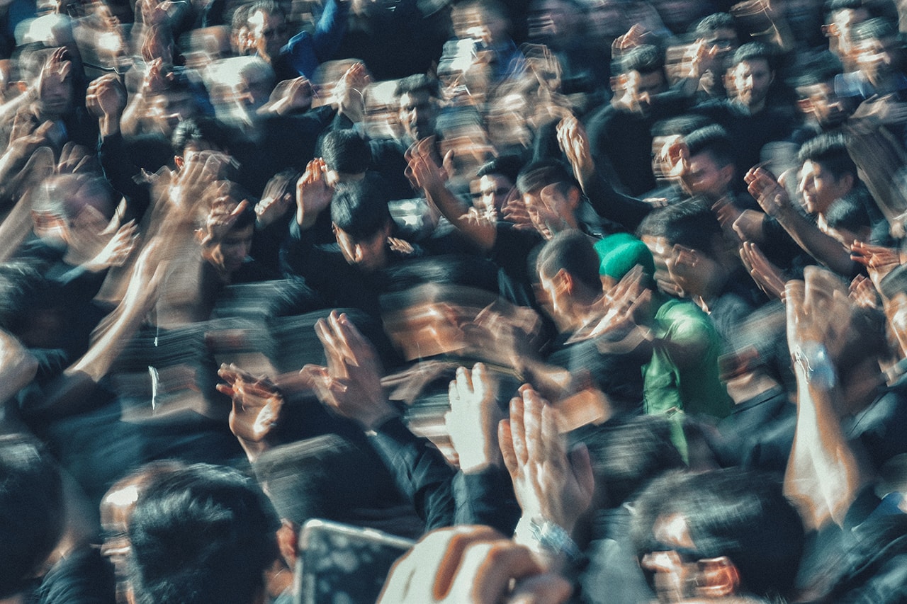 Distant blurry image showing crowd of men
