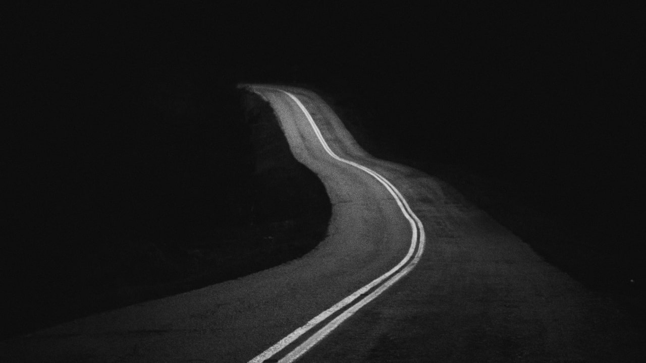 Monochrome photo of a leading road