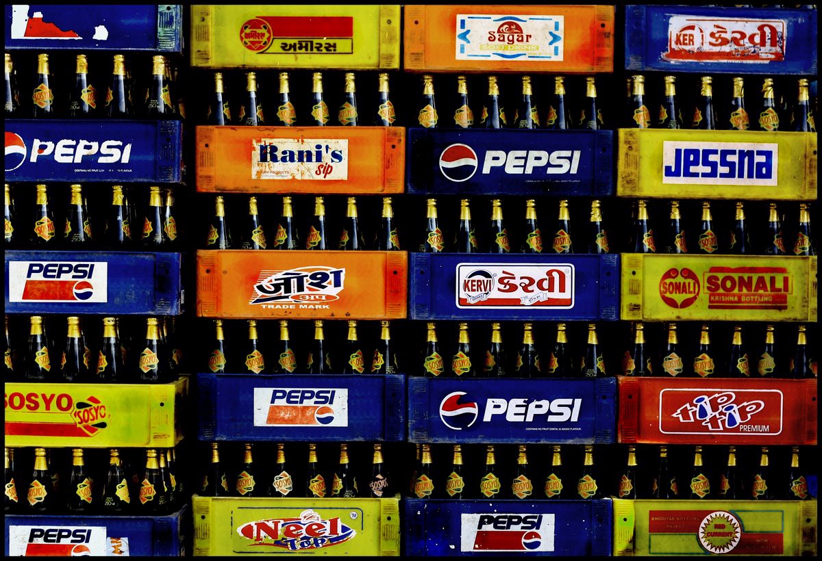 Soyso cold drink glass bottles stacked in multiple containers