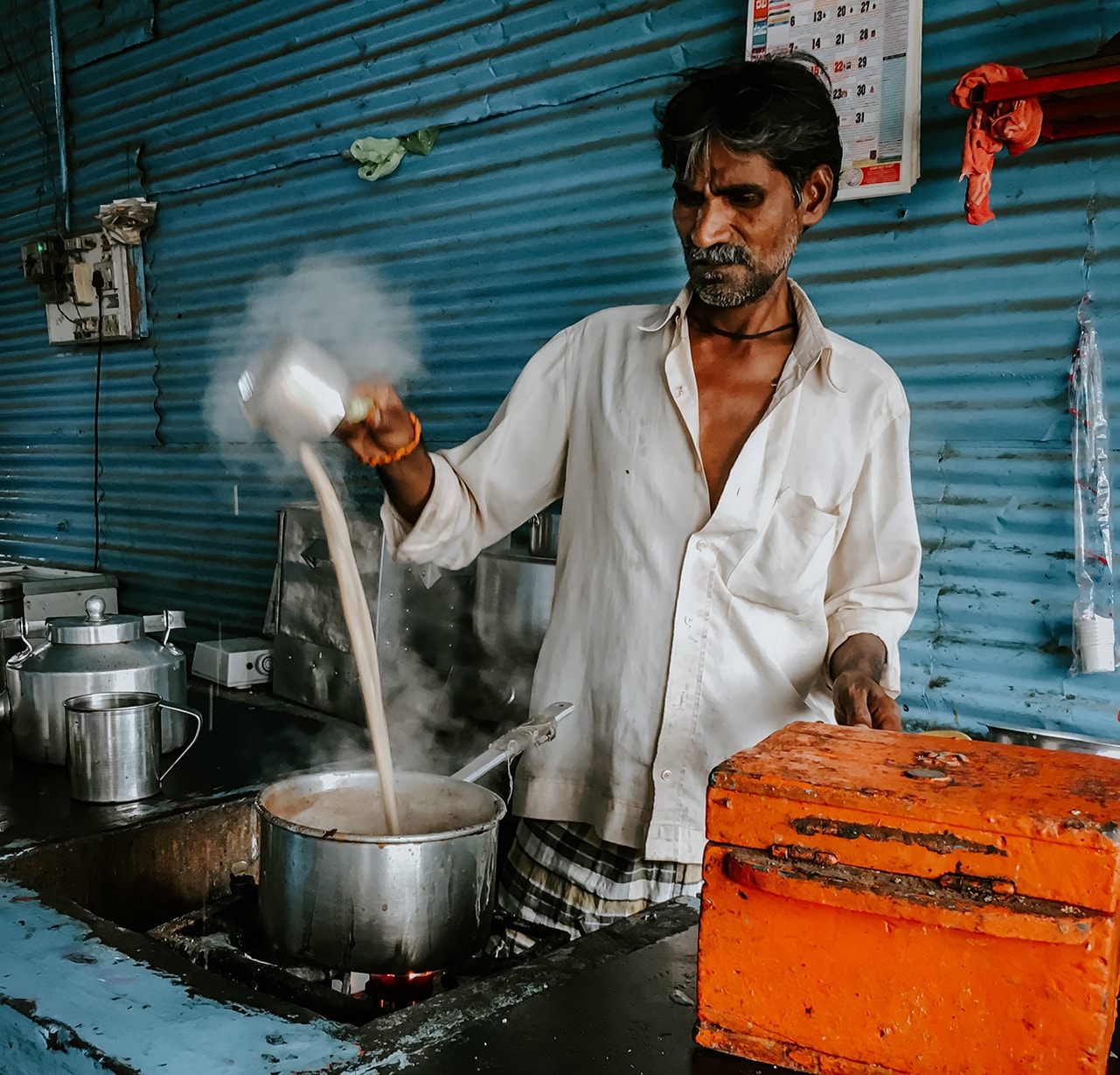 A man making tea in a tea stall